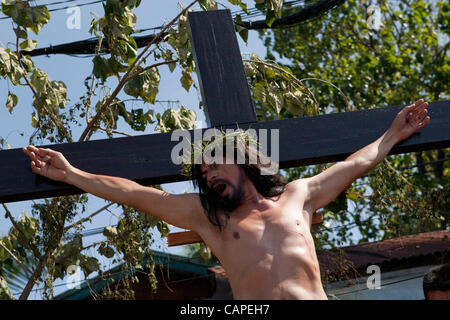 Cebu City, Philippines, Good-Friday, 6.April 2012: Gilbert Bargayo, being nailed to the cross for the 17th Good Friday. Stock Photo