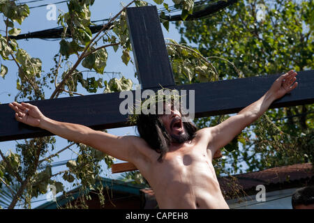 Cebu City, Philippines, Good-Friday, 6.April 2012: Gilbert Bargayo, being nailed to the cross for the 17th Good Friday. Stock Photo