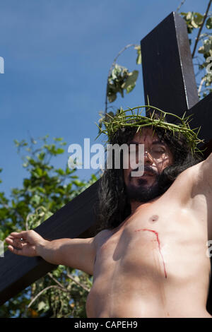 Cebu City, Philippines, Good-Friday, 6.April 2012: Gilbert Bargayo, being nailed to the cross for the 17th Good Friday. Stock Photo