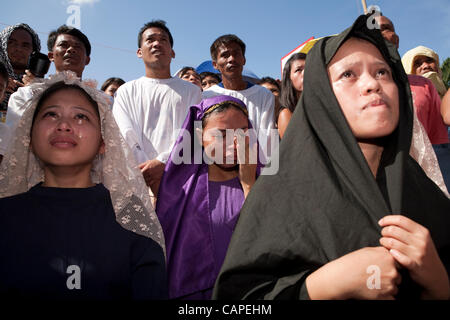 Cebu City, Philippines, Good-Friday, 6.April 2012: Gilbert Bargayo, being nailed to the cross for the 17th Good Friday. Stock Photo