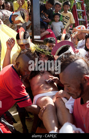 Cebu City, Philippines, Good-Friday, 6.April 2012: Gilbert Bargayo, being nailed to the cross for the 17th Good Friday. Stock Photo