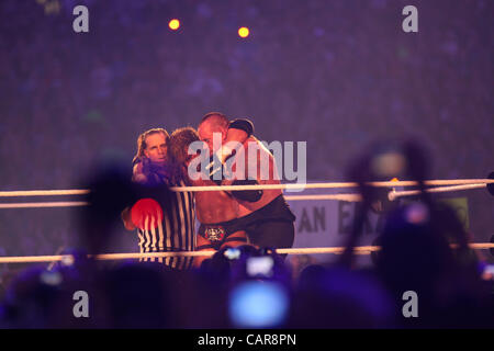 WWE legends The Undertaker wrestled Triple H at Wrestlemania 28 in Miami, FL at Sun Life Stadium. WWE Hall of Famer Shawn Michaels served as the special referee. The Undertaker won, advancing his streak to 20-0 at Wrestlemania events. Stock Photo