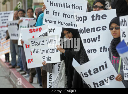 April 14, 2012 - Los Angeles, California, U.S. - Members of the Muslim community with signs and shout slogans during a protest outside the Pakistan consulate to call on the government of Pakistan to stop enabling armed groups to terrorize innocent civilians'' and arrest those responsible for massacr Stock Photo