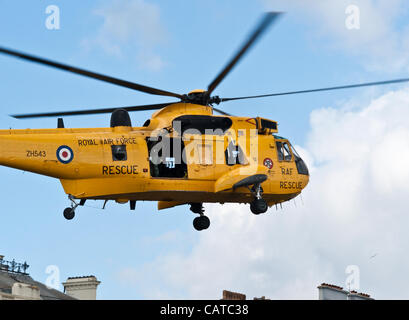 Plymouth, UK. 19 Apr, 2012. An RAF rescue helicopter takes off from Plymouth Hoe after delivering the flag for Armed Forces Day due to be celebrated in June. Stock Photo