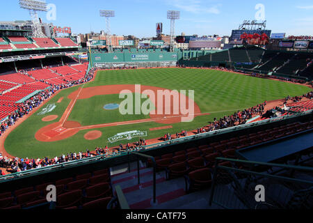 Boston, Massachusetts, USA. April 19, 2012. One Hour after Fenway Park opened to the public for an open house on its 100th Anniversary. Red Sox fans lined up along the edge of the stadium in order to catch a glimpse of the dugouts, Green Monster and bullpens. Stock Photo