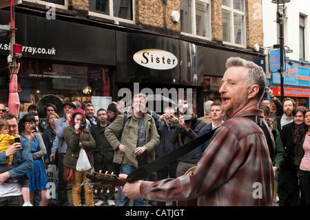 London, UK. 21/04/12. Billy Bragg musician and left-wing activist performs outside Sister Ray, the independent record shop in Berwick Street, Soho. Stock Photo