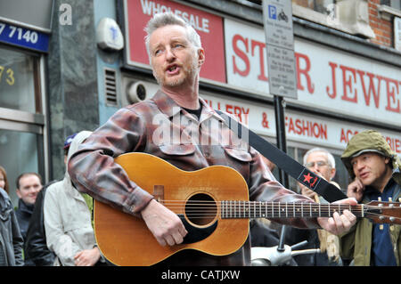 Billy Bragg performs on the street outside Sister Ray record store in Berwick Street, Soho as part of the event 'Record Store Day' to promote independent specialist record shops. 21st April 2012. Stock Photo