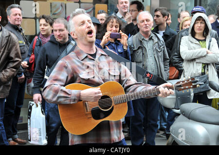 Billy Bragg performs on the street outside Sister Ray record store in Berwick Street, Soho as part of the event 'Record Store Day' to promote independent specialist record shops. 21st April 2012. Stock Photo