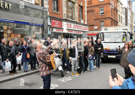 Billy Bragg stops the traffic as he performs on the street outside Sister Ray record store in Berwick Street, Soho as part of the event 'Record Store Day' to promote independent specialist record shops. 21st April 2012. Stock Photo