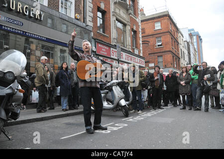 Billy Bragg performs on the street outside Sister Ray record store in Berwick Street, Soho as part of the event 'Record Store Day' to promote independent specialist record shops. 21st April 2012. Stock Photo