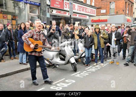 Billy Bragg performs on the street outside Sister Ray record store in Berwick Street, Soho as part of the event 'Record Store Day' to promote independent specialist record shops. 21st April 2012. Stock Photo