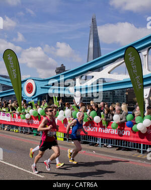 London, UK 22nd April 2012. Runners in 32nd City Marathon cross Tower Bridge with Shard in the background. Credit Line : Credit:  Charles Bowman / Alamy Live News. Stock Photo