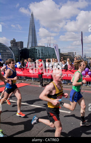 London, UK 22nd April 2012. Runners in 32nd City Marathon cross Tower Bridge with Shard in the background. Credit Line : Credit:  Charles Bowman / Alamy Live News. Stock Photo