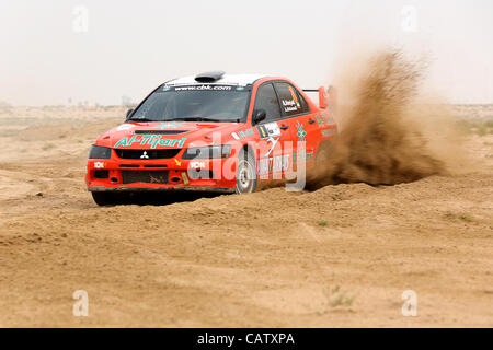 Safir, Kuwait - April 13, 2012: Mitsubishi Lancer Evo IX #8 driver Meshal Alnejadi and co-driver Ali Alshemali participates in the Kuwait International Rally organized by The Quarter Mile Motorsports Club (QMMC) & Motorcycle Club on April 13, 2012 in southern Kuwait. Stock Photo