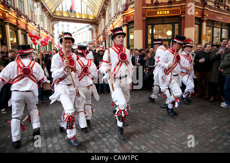 Leadenhall Market, London, United Kingdom. 23.04.2012 Picture shows Morris Dancers at Leadenhall Market celebrating St George's Day, as a crowd enjoys the festivities for the patron saint of England,  at the covered market in the City of London. Stock Photo