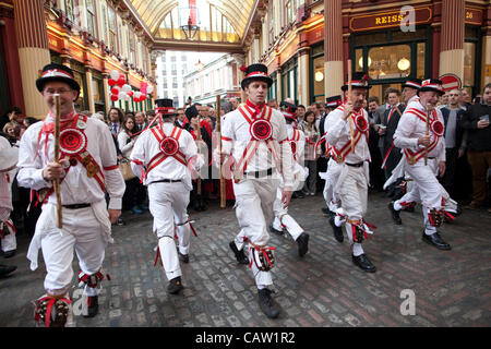 Leadenhall Market, London, United Kingdom. 23.04.2012 Picture shows Morris Dancers at Leadenhall Market celebrating St George's Day, as a crowd enjoys the festivities for the patron saint of England,  at the covered market in the City of London. Stock Photo