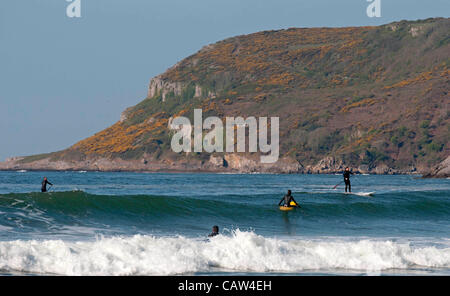 Swansea - UK - 24th April 2012 - Surfers making the most of the sunshine and surf at Caswell Bay on the Gower Peninsula near Swansea this morning. Stock Photo