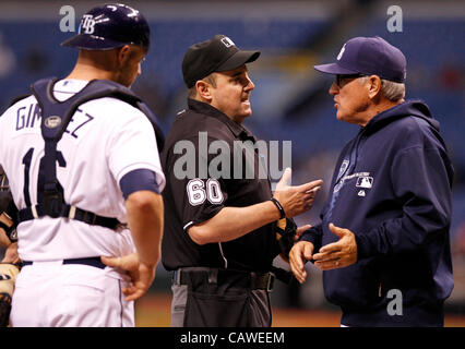 April 25, 2012 - St. Petersburg, FL, USA - JAMES BORCHUCK  |   Times.SP 351727 BORC rays (04/25/12)   (St. Petersburg, FL) Joe Maddon, right, argues a catcher interferance call with home plate umpire Marty Foster, center, as catcher Chris Gimenez, left, watches in the second inning during the Rays g Stock Photo