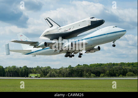 The NASA Space shuttle Enterprise mounted atop a NASA 747 Shuttle Carrier Aircraft takes off from Dulles Airport April 27, 2012 outside Washington, DC.  The Enterprise is being moved from the Smithsonian Museum to the Intrepid Sea, Air & Space Museum in New York. Stock Photo