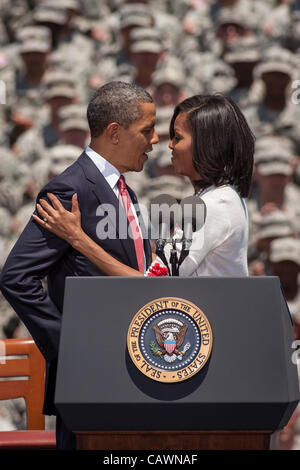 US President Barack Obama and first lady Michelle Obama embrace before addressing soldiers from the 3rd Infantry Division at Fort Stewart army base on April 27, 2012 in Hinesville, Georgia.  Obama came to the base to sign an executive order requiring more disclosure from colleges that target militar Stock Photo