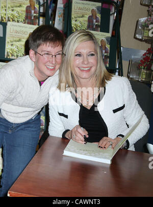 April 27, 2012 - New York, New York, U.S. - Actress/singer OLIVIA NEWTON-JOHN poses with a fan during her new book signing 'Livwise' held at Barnes and Noble 18th Street. (Credit Image: © Nancy Kaszerman/ZUMAPRESS.com) Stock Photo