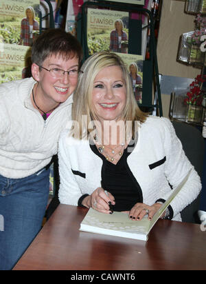 April 27, 2012 - New York, New York, U.S. - Actress/singer OLIVIA NEWTON-JOHN poses with a fan during her new book signing 'Livwise' held at Barnes and Noble 18th Street. (Credit Image: © Nancy Kaszerman/ZUMAPRESS.com) Stock Photo