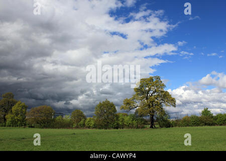 The skies finally clear after the April showers continue across Britain, at Tolworth Court Farm, green belt land in South West London, England, UK Stock Photo