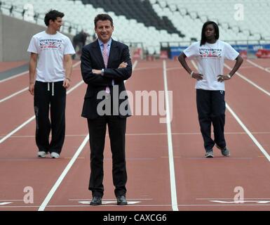 OLYMPIC STADIUM, STRATFORD, LONDON, UK, Wednesday. 02/05/2012.Lord Sebastian Coe (LOCOG Chair) stands on the finishing line with Guy Learmonth (left) and Shakira Wright. BUCS Athletics launch press conference. The first event to be held in the new stadium. Stock Photo