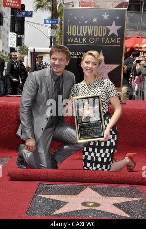 Jeremy Renner, Scarlett Johansson at the induction ceremony for Star on the Hollywood Walk of Fame for Scarlett Johansson, Hollywood Boulevard, Los Angeles, CA May 2, 2012. Photo By: Michael Germana/Everett Collection Stock Photo