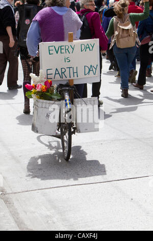 Protesters Marching and Cyclist with Earth Day Sign, May Day Rally, May 1, 2012, Seattle, Washington Stock Photo