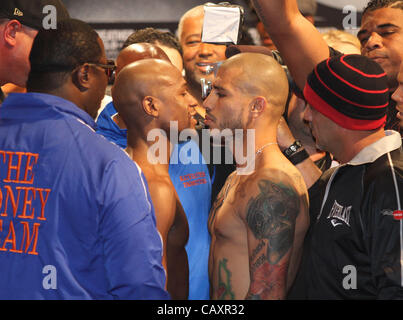 (L to R) Miguel Cotto and Floyd Mayweather face off at the MGM Grand Garden Arena in Las Vegas on May 4, 2012, one day before Cotto attempts to defend his WBA Super Welterweight title against Mayweather.  The victor will also clinch the vacant WBC Diamond Super Welterweight title. Stock Photo