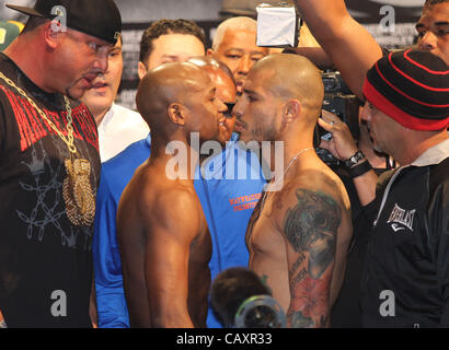 (L to R) Miguel Cotto and Floyd Mayweather face off at the MGM Grand Garden Arena in Las Vegas on May 4, 2012, one day before Cotto attempts to defend his WBA Super Welterweight title against Mayweather.  The victor will also clinch the vacant WBC Diamond Super Welterweight title. Stock Photo