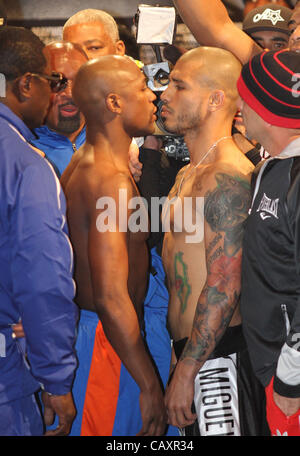 (L to R) Miguel Cotto and Floyd Mayweather face off at the MGM Grand Garden Arena in Las Vegas on May 4, 2012, one day before Cotto attempts to defend his WBA Super Welterweight title against Mayweather.  The victor will also clinch the vacant WBC Diamond Super Welterweight title. Stock Photo