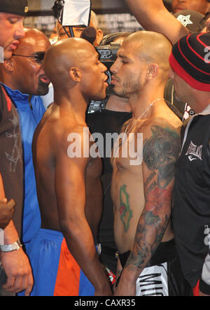 (L to R) Miguel Cotto and Floyd Mayweather face off at the MGM Grand Garden Arena in Las Vegas on May 4, 2012, one day before Cotto attempts to defend his WBA Super Welterweight title against Mayweather.  The victor will also clinch the vacant WBC Diamond Super Welterweight title. Stock Photo