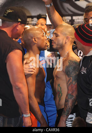 (L to R) Miguel Cotto and Floyd Mayweather face off at the MGM Grand Garden Arena in Las Vegas on May 4, 2012, one day before Cotto attempts to defend his WBA Super Welterweight title against Mayweather.  The victor will also clinch the vacant WBC Diamond Super Welterweight title. Stock Photo