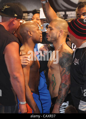 (L to R) Miguel Cotto and Floyd Mayweather face off at the MGM Grand Garden Arena in Las Vegas on May 4, 2012, one day before Cotto attempts to defend his WBA Super Welterweight title against Mayweather.  The victor will also clinch the vacant WBC Diamond Super Welterweight title. Stock Photo