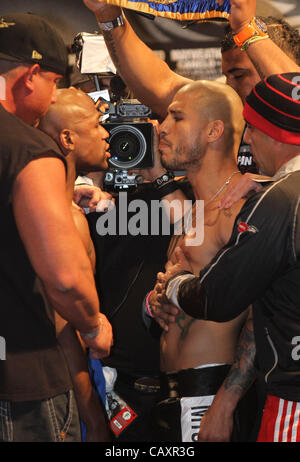 (L to R) Miguel Cotto and Floyd Mayweather face off at the MGM Grand Garden Arena in Las Vegas on May 4, 2012, one day before Cotto attempts to defend his WBA Super Welterweight title against Mayweather.  The victor will also clinch the vacant WBC Diamond Super Welterweight title. Stock Photo