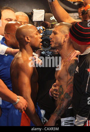 (L to R) Miguel Cotto and Floyd Mayweather face off at the MGM Grand Garden Arena in Las Vegas on May 4, 2012, one day before Cotto attempts to defend his WBA Super Welterweight title against Mayweather.  The victor will also clinch the vacant WBC Diamond Super Welterweight title. Stock Photo