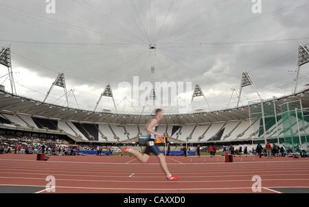 OLYMPIC STADIUM OFFICIAL OPENING, OLYMPIC PARK, STRATFORD, LONDON, UK, Saturday. 05/05/2012. Scott Macaulay (GLC) runs on the new 2012 Olympic Stadium track. 2012 Hours to Go. An Evening of Athletics and Entertainment. Stock Photo