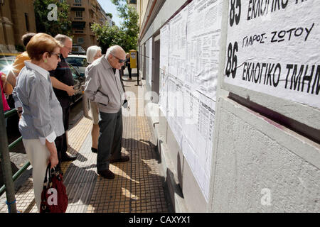 Greek Elections, Athens, Greece. 05.05.2012 Image shows an elderly Greek man finding his name on the listings outside the local Voting Station at one of the listing boards displayed in the centre of Athens, ahead of tomorrows Greek General Election. Stock Photo