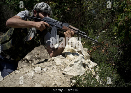 May 6, 2012 - Free Syrian Army member fighting with regular Syrian army in the hills of Idlib province, northern Syria...The Free Syrian Army continues to oppose the Assad regime throughout Syria despite the Syrian army targeting many of the villages and towns thought to be supportive of the Free Sy Stock Photo