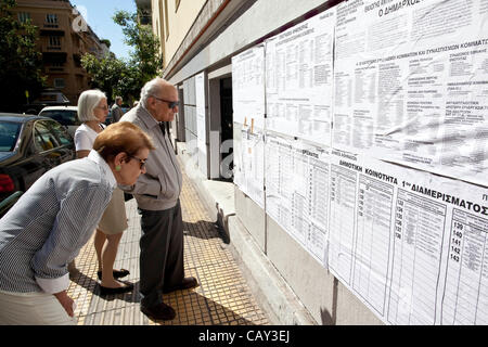 Greek Elections. Kolonaki, Athens, Greece. 06.05.2012 Image shows Greek people outside checking the listings at the Polling Station on election day in the wealthy neighbourhood of Kolonaki, Athens, Greece. Stock Photo