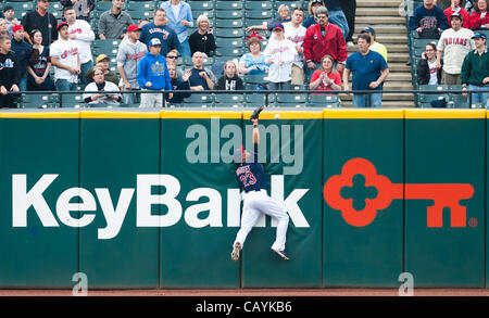 CLEVELAND, OH USA - MAY 8:  Cleveland Indians center fielder Michael Brantley (23) leaps but can't make the catch on a hit by Chicago White Sox first baseman Adam Dunn (32) during the first inning at Progressive Field in Cleveland, OH, USA on Tuesday, May 8, 2012. Stock Photo