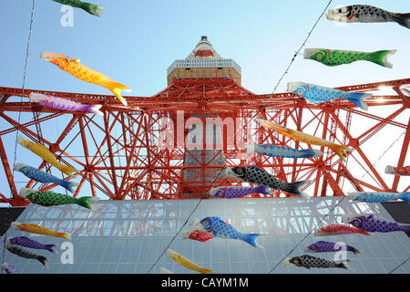 May 05, 2012, Tokyo, Japan - Many people gathered under the Tokyo Tower to assist the Koinobori (meaning the carp streamer) on the fifth of May,  the Children`s Day in Japan. Koinobori are carp-shaped wind socks decorated with carp pattern drawings on paper, cloth or other materials, traditionally f Stock Photo