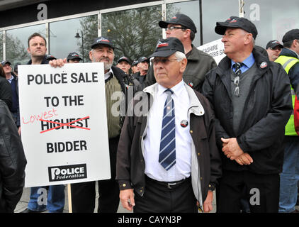 Off duty police officers holding a banner with the slogan 'Police sale to the lowest bidder' as they protest against cuts in the service. Thursday 10th May 2012. Millbank, London, UK. Stock Photo