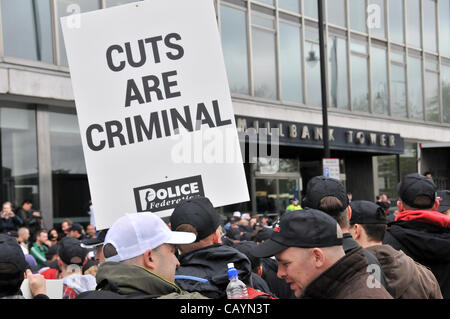 Off duty police officers holding banners with the slogan 'cuts are criminal outside Millbank Tower as they protest against cuts in the service. Thursday 10th May 2012. Millbank, London, UK. Stock Photo