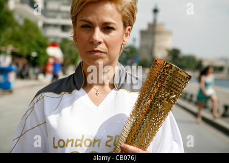 The Olympic flame arrives in Thessaloniki. The torchbearer, Yota Economou lit the altar in front of the city's symbol, the White Tower. Thessaloniki, Greece. May 13, 2012. Stock Photo