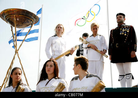 The Olympic flame arrives in Thessaloniki. The torchbearer, Yota Economou lit the altar in front of the city's symbol, the White Tower. Thessaloniki, Greece. May 13, 2012. Stock Photo