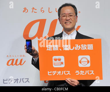 May 15, 2012, Tokyo, Japan - President Koji Tanaka of Japans KDDI introduces a new lineup of mobile phone summer models and video and music distribution services for mobile phones during a launch in Tokyo on Tuesday, May 15, 2012. The countrys second largest carrier unveiled five new types of smartp Stock Photo
