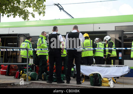 Croydon UK. 16 May, 2012 . A 28-year-old woman was dragged 30m under a tram in Croydon, South London after trying to cross tram lines. Around 50 emergency services including fire, ambulance and police were on hand to extract the victim from under the tram. She was taken to hospital by air ambulance.